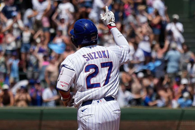 Chicago Cubs' Seiya Suzuki, left, of Japan, celebrates as he rounds the bases after hitting a three-run home run during the first inning of a baseball game against the San Diego Padres in Chicago, Wednesday, July 1, 2026. (AP Photo/Nam Y. Huh)