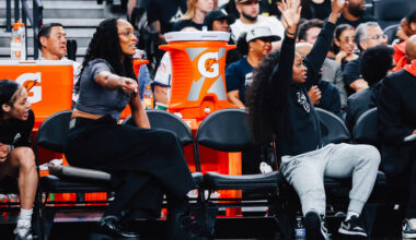 Aces center A'ja Wilson and teammate Dana Evans point to the Aces’ side of the cour ...