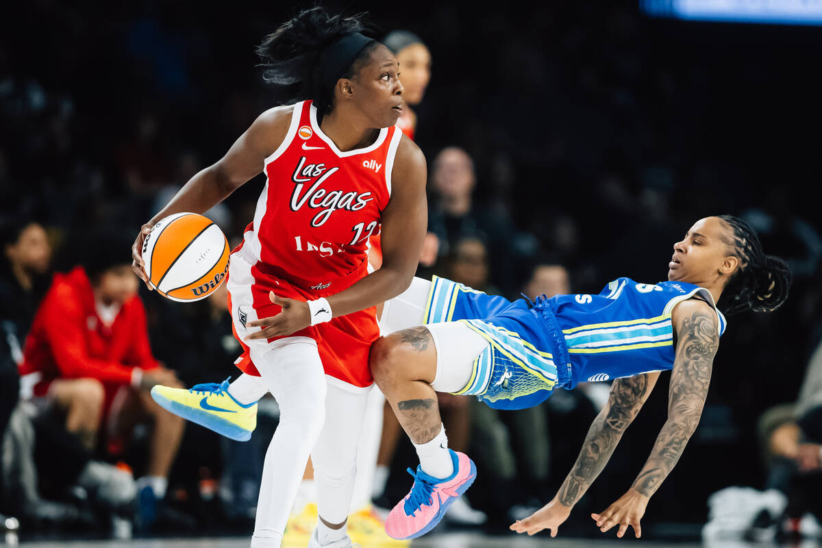Dallas Wings guard Aziaha James (10) falls against Aces guard Chelsea Gray (12) during a WNBA b ...