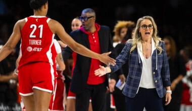 Aces head coach Becky Hammon high fives a player during a game against the Phoenix Mercury at M ...