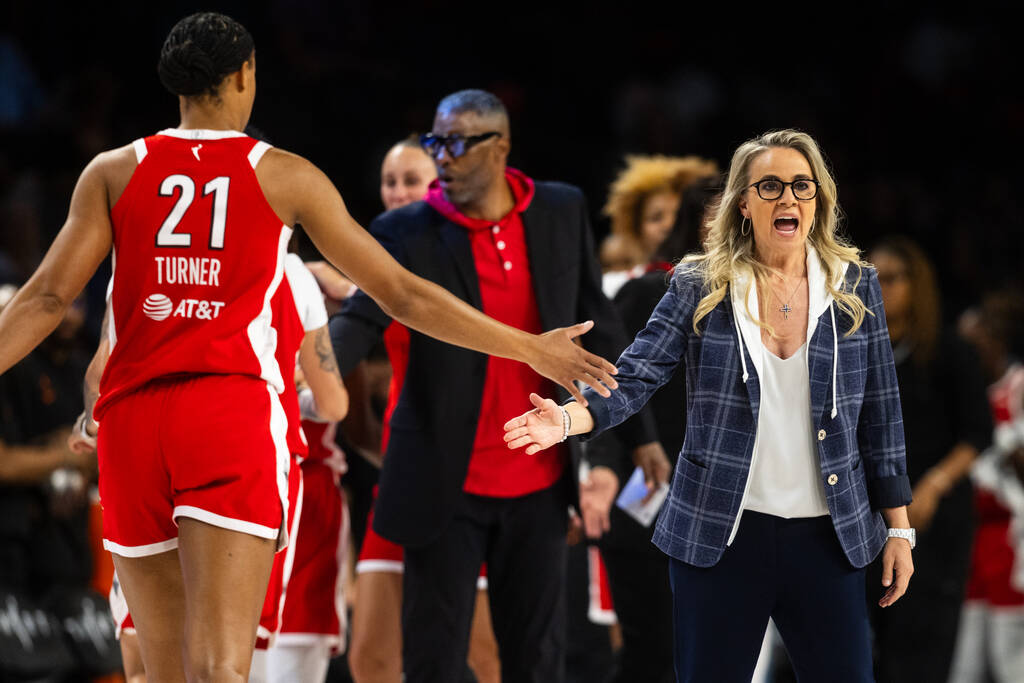 Aces head coach Becky Hammon high fives a player during a game against the Phoenix Mercury at M ...