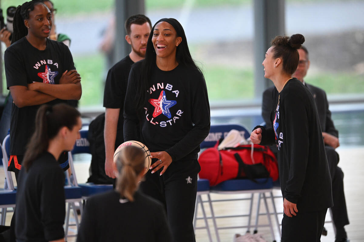 WNBA All-Star A'ja Wilson, center, jokes around during basketball practice in Chicago, Fri ...