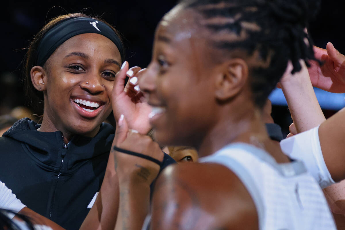 Aces guard Jackie Young (0) grins as her team cheers after beating Portland Fire on Tuesday, Ju ...