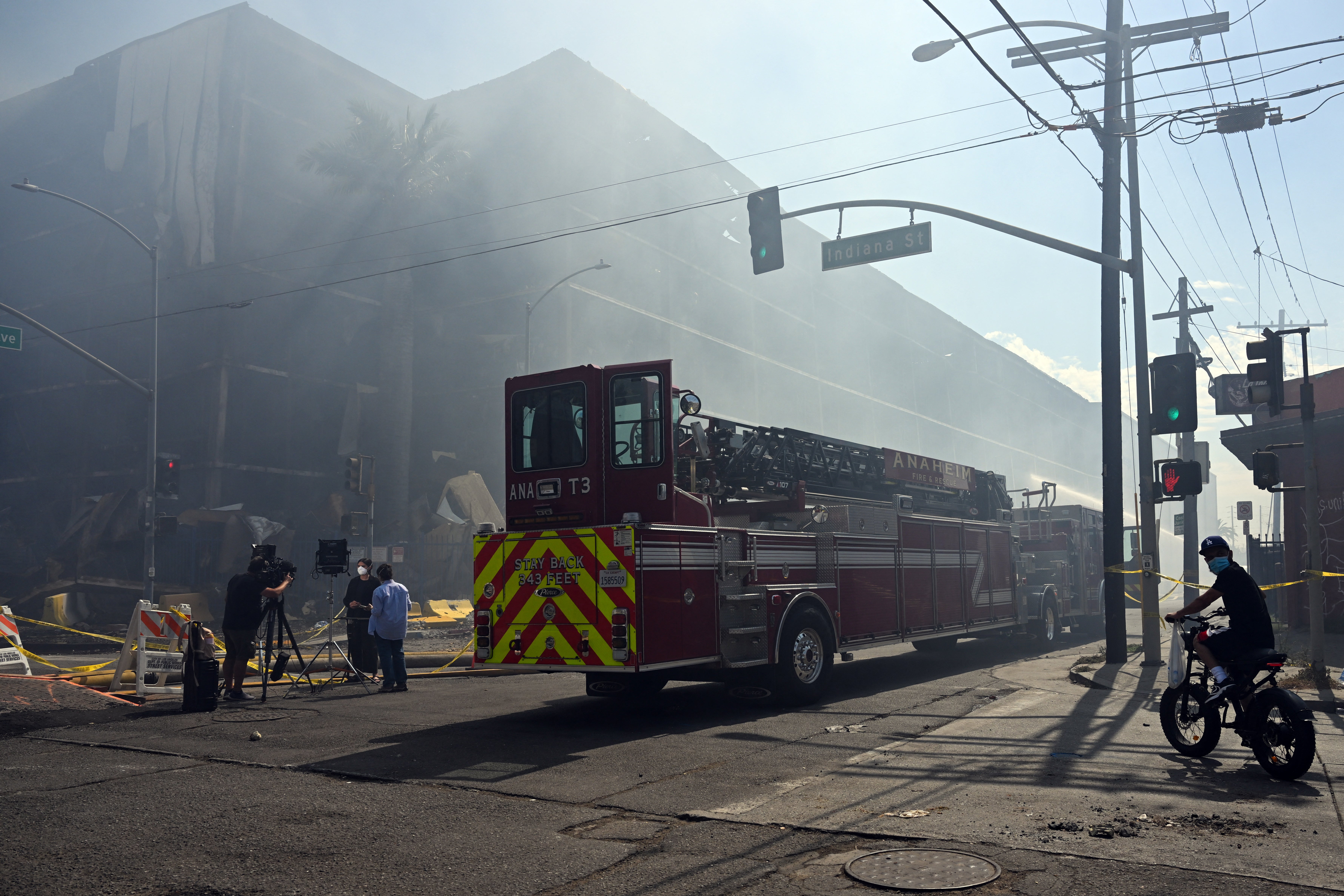 Smoke fill the air as firefighters continue fighting the Lineage cold storage warehouse fire in the Boyle Heights neighborhood