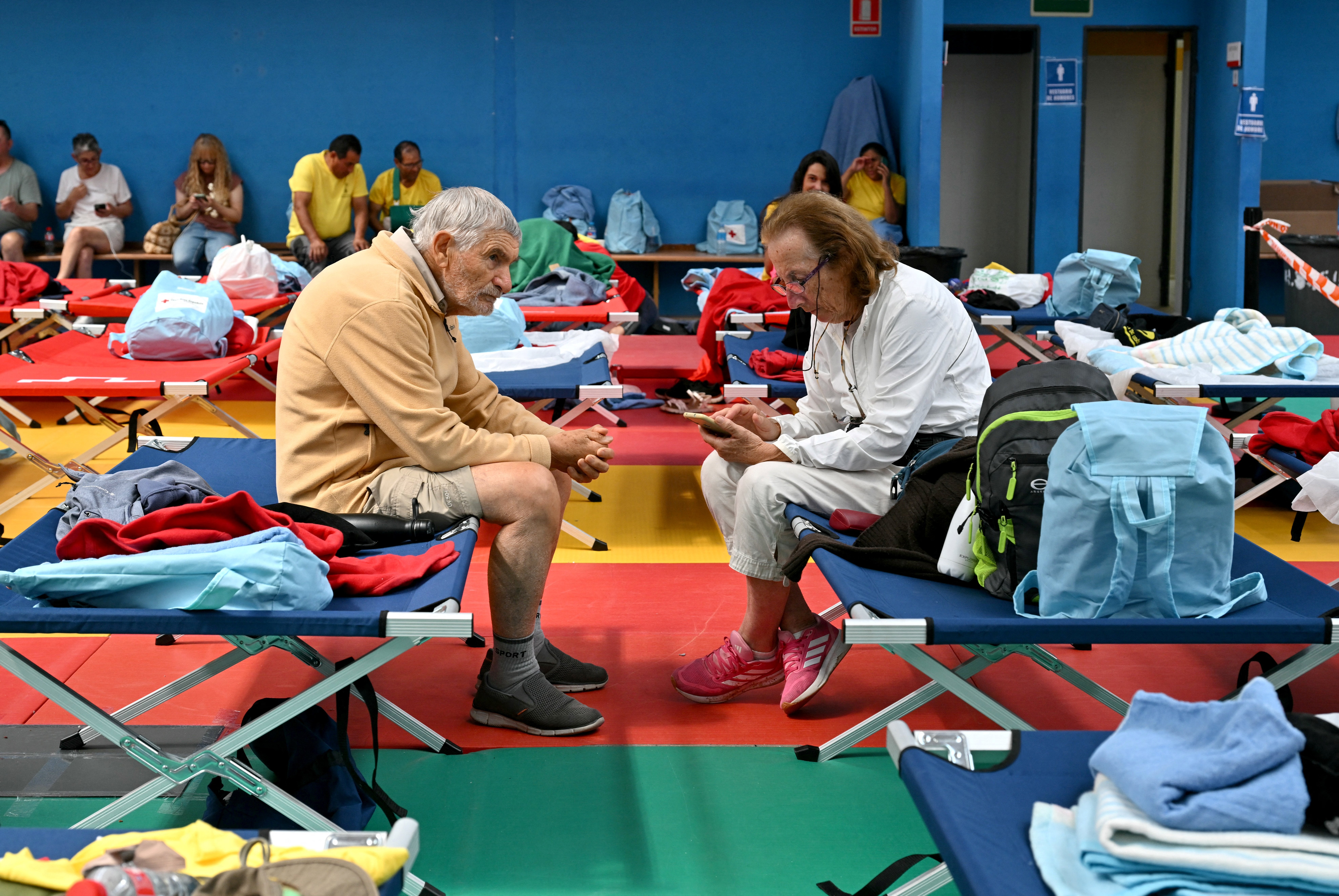 Elderly persons evacuated amid wildfires rest in a sports hall in Villaviciosa de Odon, 20 kms west of Madrid, on July 25, 2026.