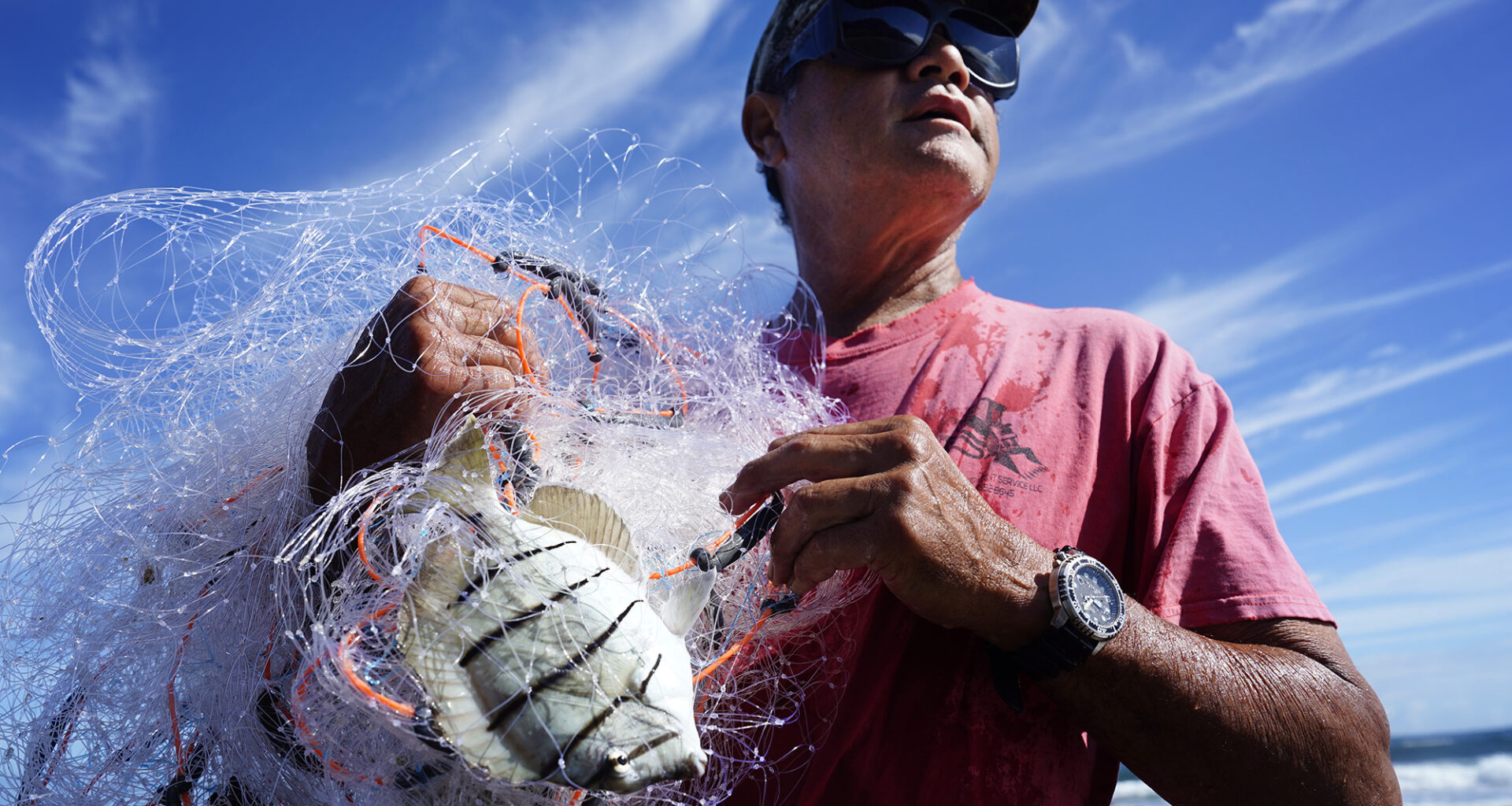 Keli‘i Alapa‘i yells to his son after catching a few manini, also called convict tangs, in Hāʻena community fishing waters Sunday, June 28, 2026, in Hāʻena.