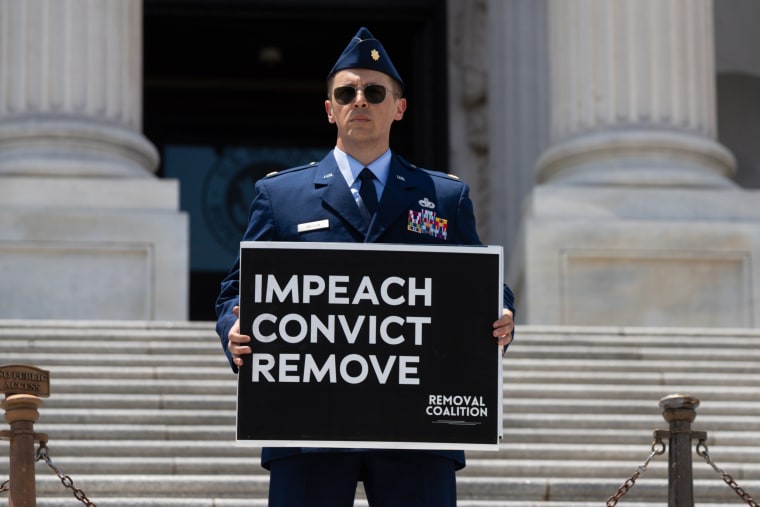 U.S. Air Force Major Jason Watson calls for the impeachment and removal of President Donald Trump on the Capitol steps.