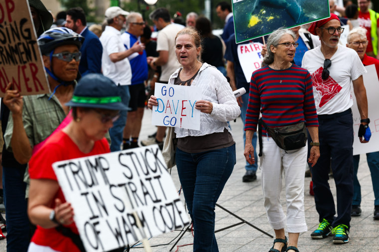 Protesters march before former Olympian David Hearn's arraignment on July 9, 2026 in Washington, D.C. Hearn was indicted for destruction of property after allegedly damaging the Lincoln Memorial Reflecting Pool. 