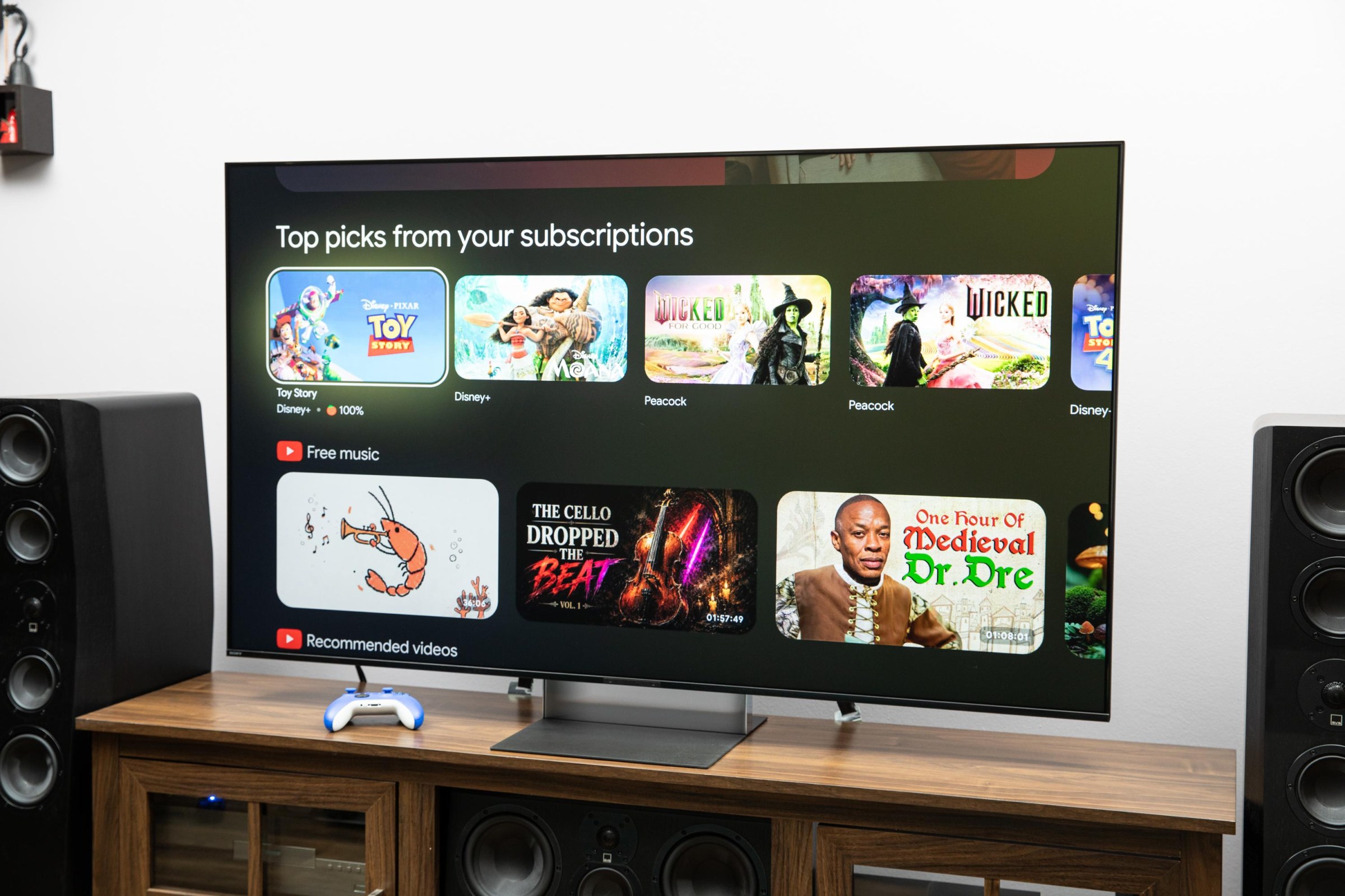 The Sony Bravia 9 II RGB LED TV on a wooden credenza with SVS speakers on either side.