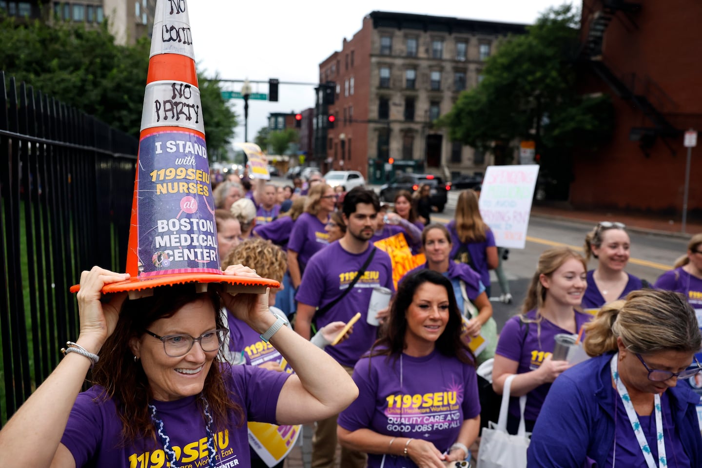 Beth Kane, a nurse at Boston Medical Center, joined picketers outside the hospital Wednesday with a nod to the Scottish World Cup fans' playfulness around traffic cones.