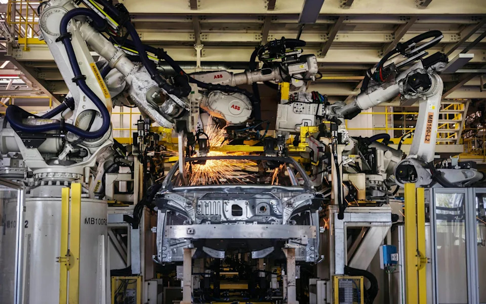 Robotic arms are used to weld parts on the body of a vehicle on the production line for electric vehicle maker Zeekr at its factory