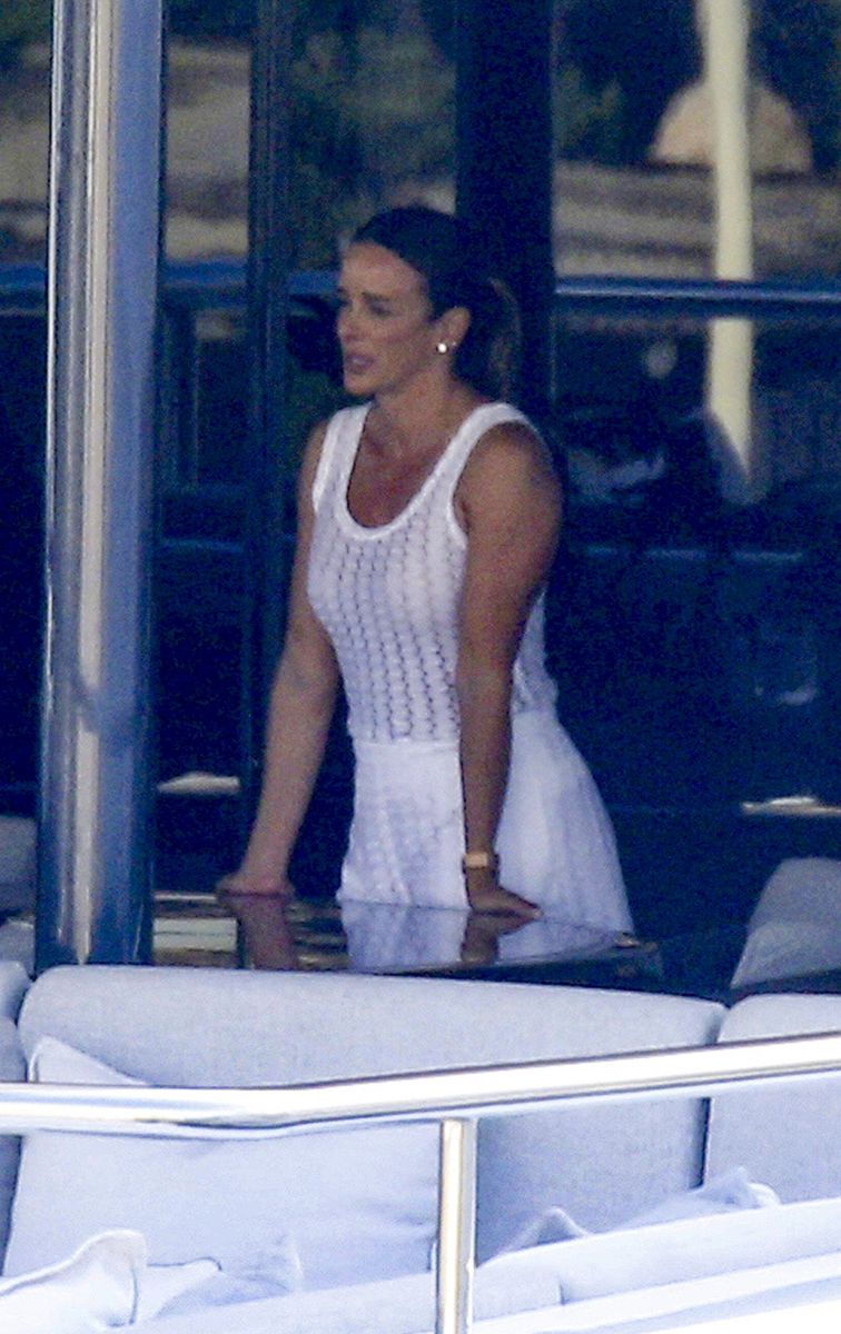 Yvette Prieto's polished beauty look featured a sleek center-parted ponytail and understated accessories that complemented her timeless resort style.