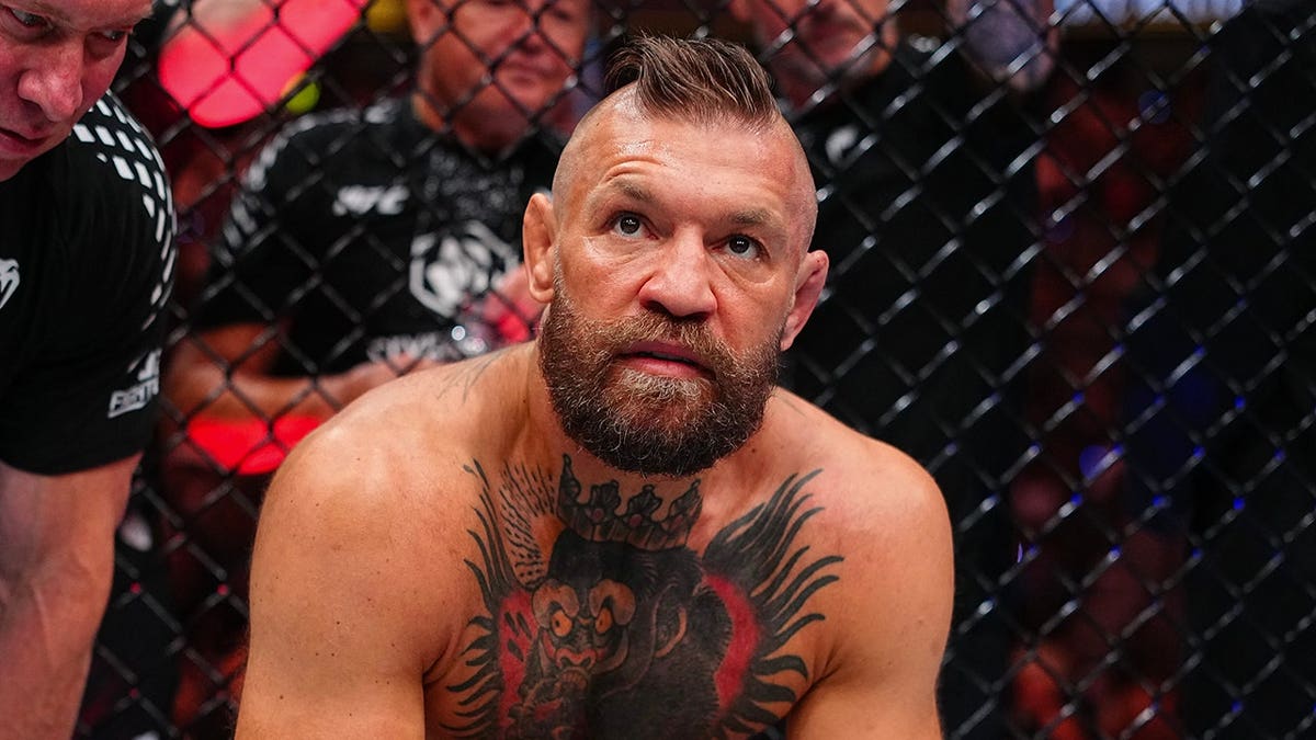 Conor McGregor reacts after an injury stoppage in a UFC welterweight fight.