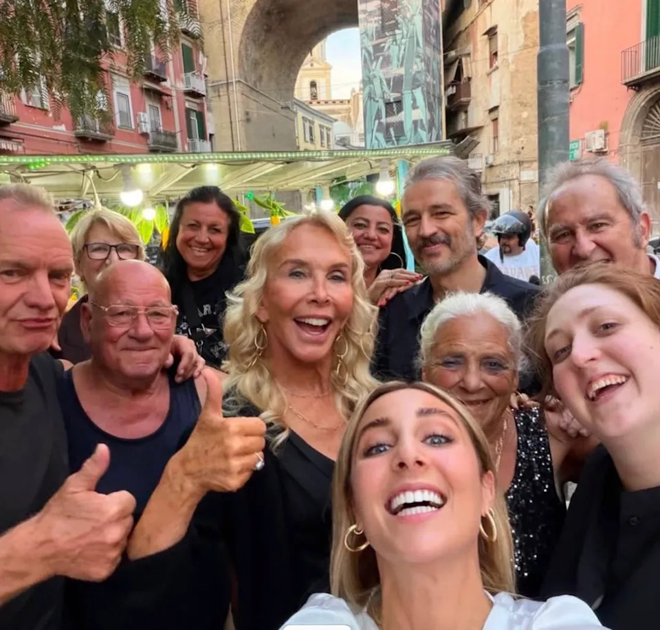 Trudie and Sting share. moment with some residents of Naples