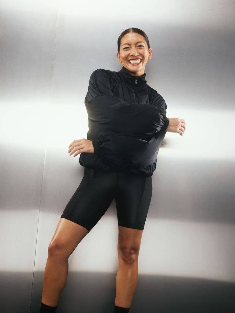 Jennifer Aniston's trainer Dani Coleman smiling in black workout wear 