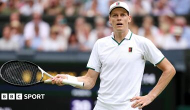 Jannik Sinner gestures with his racquet