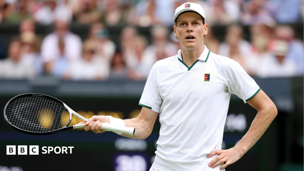 Jannik Sinner gestures with his racquet