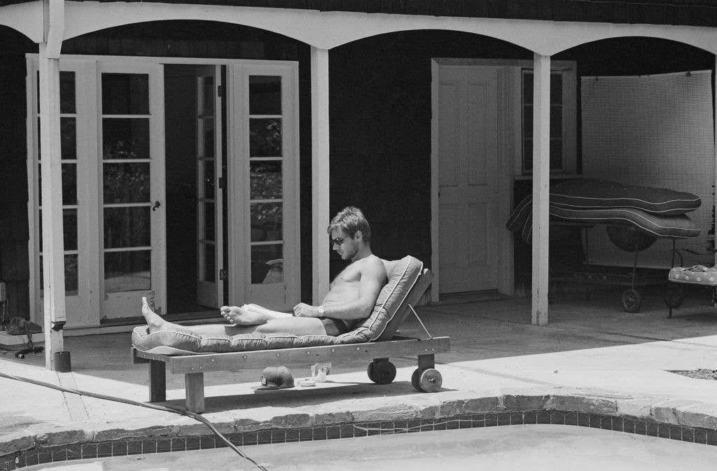 Harrison Ford in 80s on sun lounger in back yard