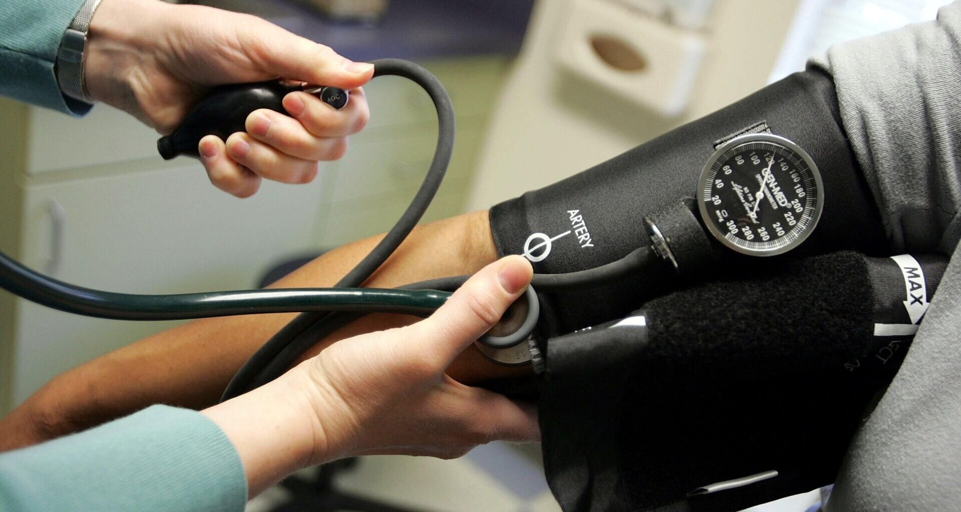 A doctor taking a patient’s blood pressure measurement.