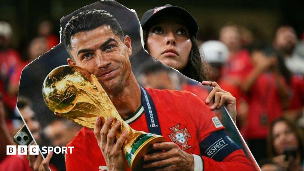 A Portugal fan holds a cardboard cutout of Cristiano Ronaldo with the World Cup trophy during the World Cup