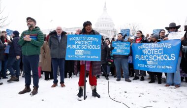 NEA leaders speakat a podium,