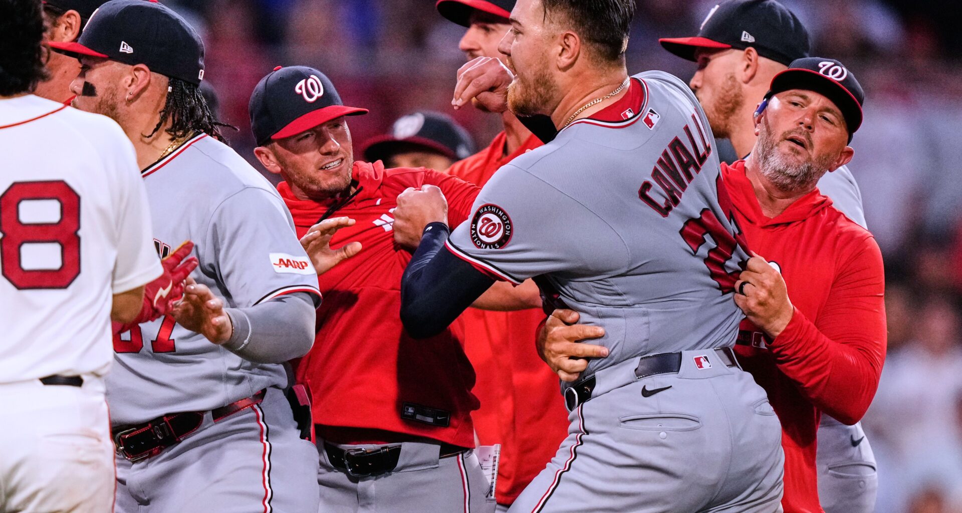 Washington Nationals' Cade Cavalli, front right, is held back as tempers flare during the fourth inning of a baseball game against the Boston Red Sox, Tuesday, June 30, 2026, in Boston. (AP Photo/Charles Krupa)