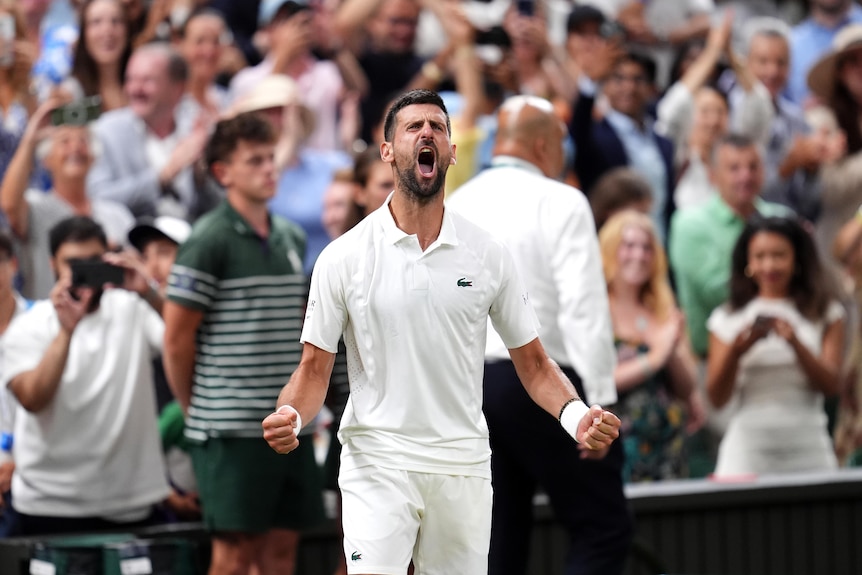 Novak Djokovic clenches his fists and yells.
