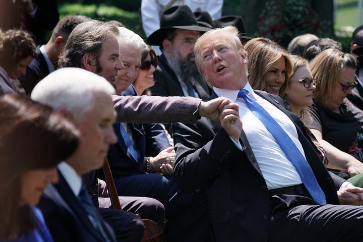 Jonathan Cain speaks to President Donald Trump at a 2019 White House event.