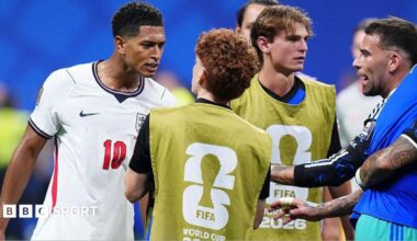 Jude Bellingham of England confronts Valentin Barco of Argentina at the World Cup semi-final between England and Argentina at Atlanta Stadium