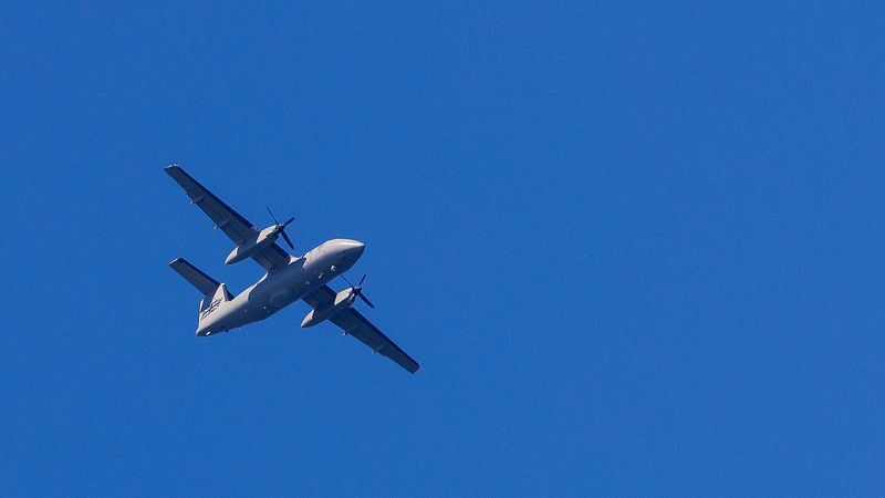 AT SEA, ENGLAND - APRIL 27: A UK military drone passes overhead as an inflatable 'small boat' carrying migrants crosses the channel after leaving northern France on April 27, 2026 in Dover, England. Last week the UK and France signed a £662 million, three-year deal to curb small boat crossings, featuring a first-of-its-kind £160 million "results-based" payment conditional on a reduction in arrivals. The agreement funds a 42% increase in French coastal personnel, a new removal centre in Dunkirk, and advanced surveillance technology. While designed to disrupt smuggling gangs and secure beaches with riot-trained officers, early reports show smugglers have already begun shifting launch sites further south to bypass the intensified patrols. (Photo by Dan Kitwood/Getty Images)
