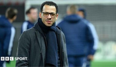 Liam Rosenior smiling and on the pitch while managing Strasbourg