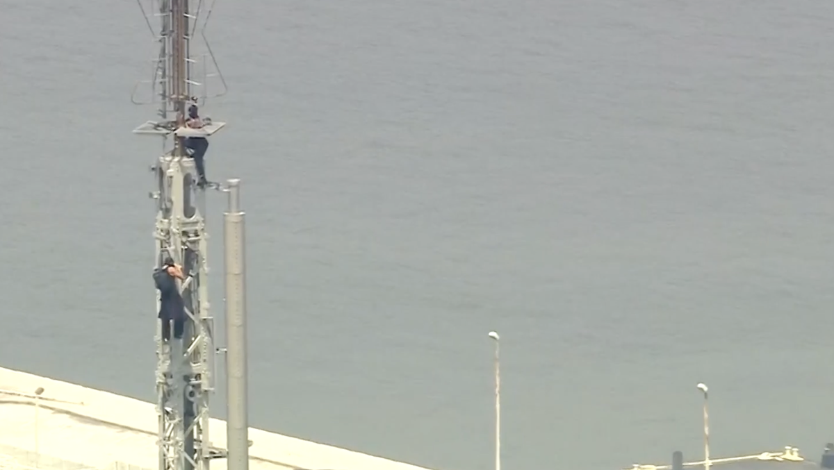 2 people fly banner at top of Empire State Building, seemingly get engaged