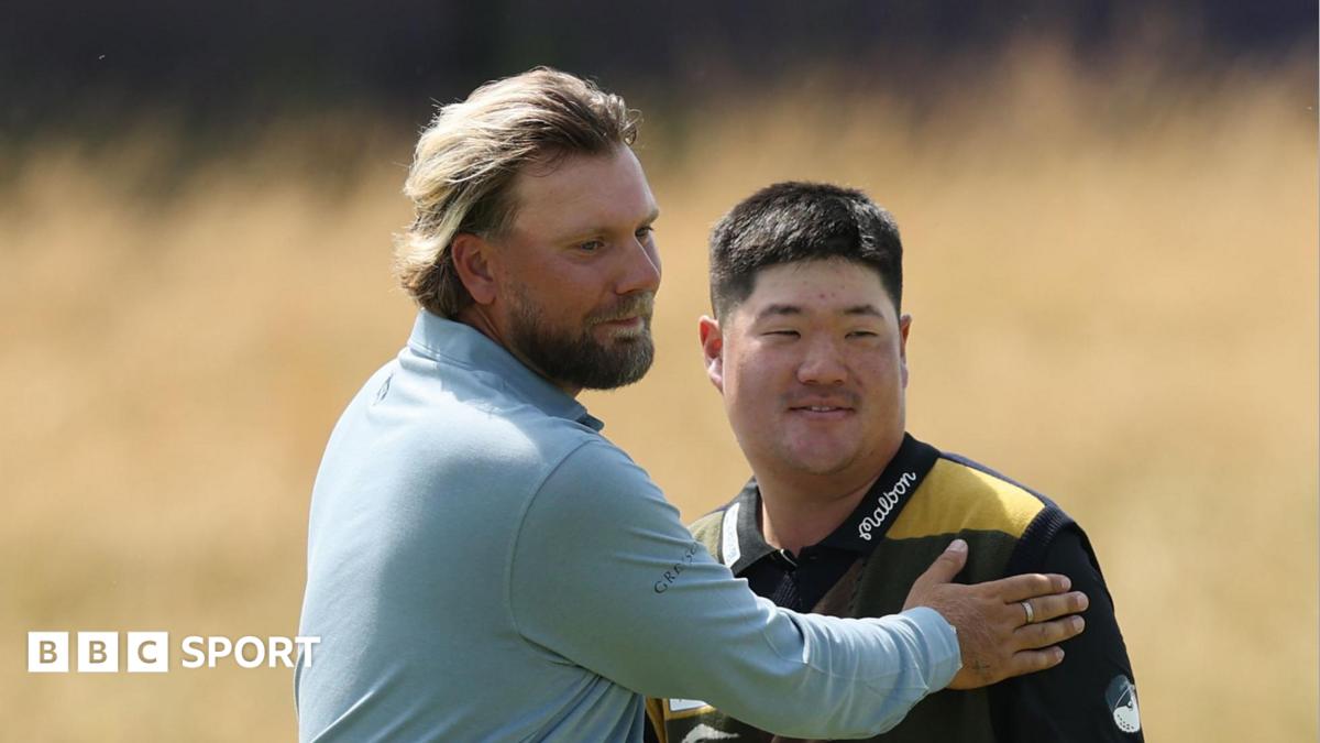 Dan Brown and Im Sung-jae embrace at the end of their round