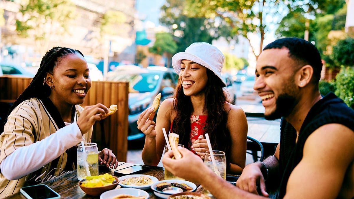 A group of friends enjoys each other's company at a dinner party.