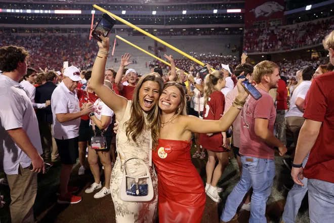Oct 5, 2024; Fayetteville, Arkansas, USA; Arkansas Razorbacks fans celebrate in front of the downed goal posts after the game against the Tennessee Volunteers at Donald W. Reynolds Razorback Stadium. Arkansas won 19-14. Mandatory Credit: Nelson Chenault-Imagn Images