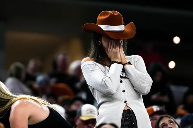 A Texas Longhorns fan reacts to a turnover on 4th and goal during the College Football Playoff semifinal game against Ohio State in the Cotton Bowl at AT&T Stadium on Friday, Jan. 10, 2024 in Arlington, Texas.