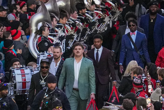 Nov 29, 2024; Athens, Georgia, USA; Georgia Bulldogs offensive lineman Tate Ratledge (69) walks through the fans and the band during the dawg walk prior to the game against the Georgia Tech Yellow Jackets at Sanford Stadium. Mandatory Credit: Dale Zanine-Imagn Images