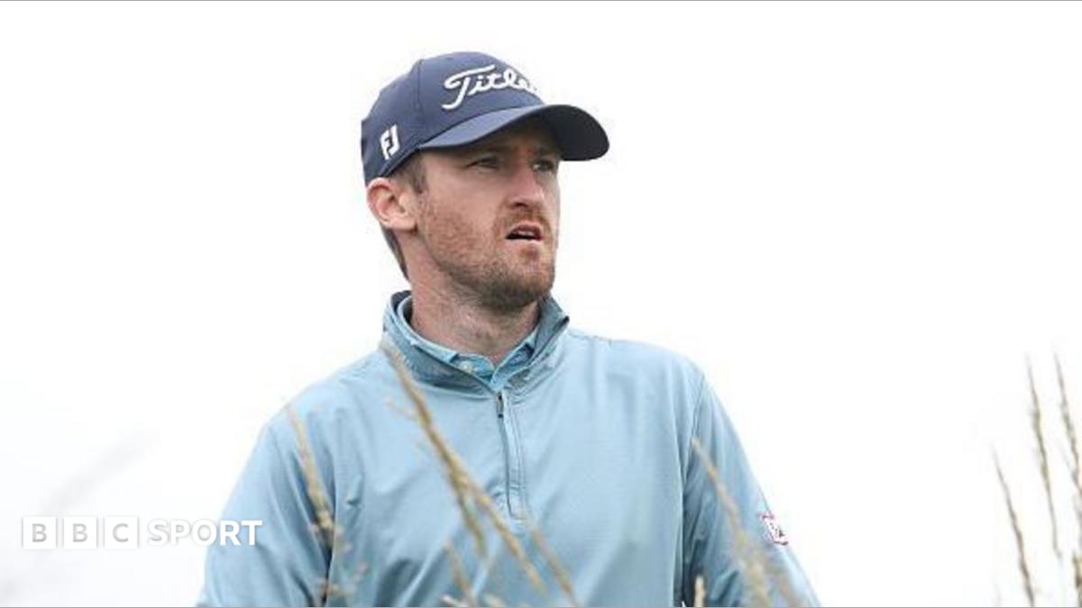 Andrew Wilson playing in The Open Final Qualifier at Dundonald Links, watching his ball as he wears a sky-blue wind-jammer