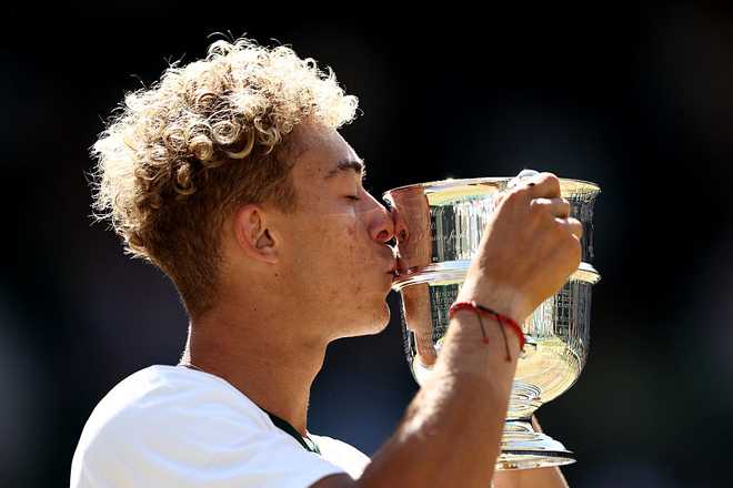 LONDON, ENGLAND - JULY 12: Jordan Lee of United States kisses his trophy following victory over Cruz Hewitt of Australia during their Boys' Singles final match on day fourteen of The Championships Wimbledon 2026 at All England Lawn Tennis and Croquet Club on July 12, 2026 in London, England. (Photo by James Fearn/Getty Images)