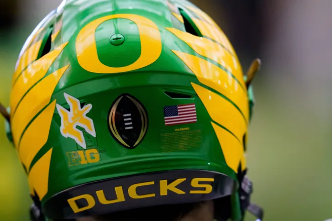 The College Football Playoff logo adorns a helmet during an open practice ahead of the Orange Bowl at the Moshofsky Center in Eugene, Oregon on Dec. 27, 2025.