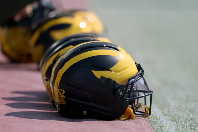 Sep 6, 2025; Norman, Oklahoma, USA; Michigan Wolverine helmets sit on the field near the sideline prior to a game against the Oklahoma Sooners at Gaylord Family-Oklahoma Memorial Stadium. Mandatory Credit: Kevin Jairaj-Imagn Images
