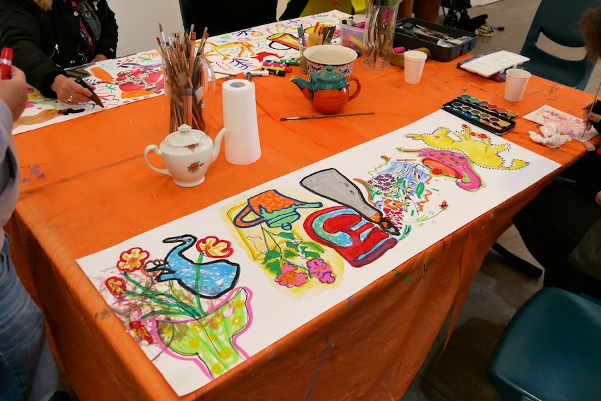 A table covered in colourful drawings.
