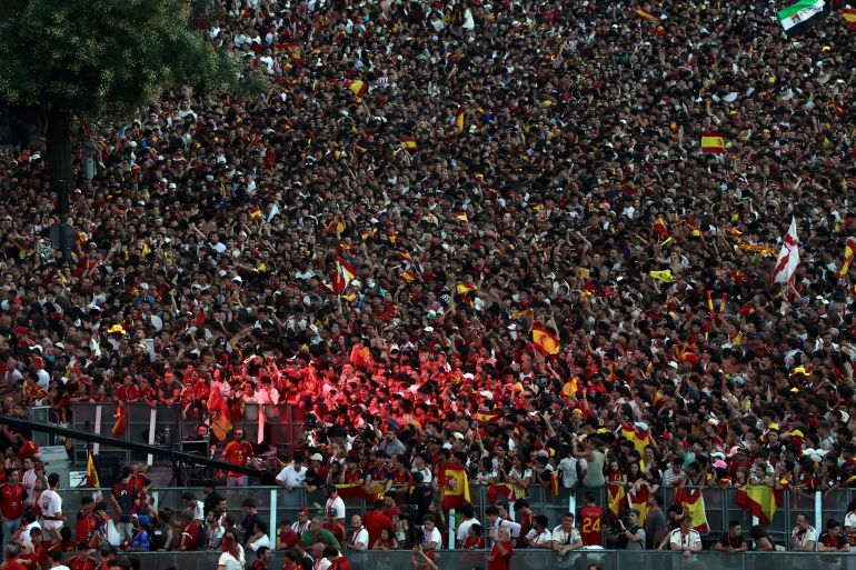 Spain fans pack Cibeles Square in Madrid on July 20, 2026, as they await the arrival of Spain's players one day after the national football team won their second World Cup title following a 1-0 victory against Argentina. Spain's World Cup winners come back home to a heroes' welcome in Madrid, where a million fans are expected to greet them after a night of raucous celebrations across the country. (Photo by Pierre-Philippe MARCOU / AFP)