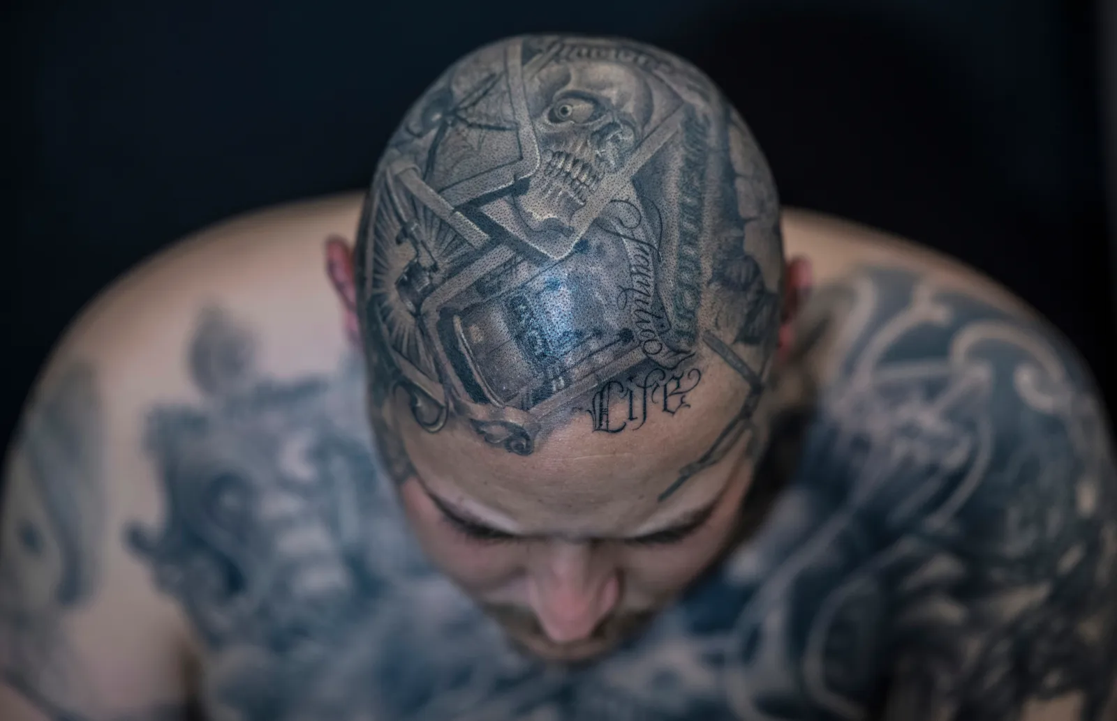 A man presents his head tattoos at a tattoo convention on April 21, 2018, in Germany where tattoo artists and enthusiasts travel from far and wide to exchange ideas, techniques and knowledge. Photo by: Boris Roessler/picture-alliance/dpa/AP Images