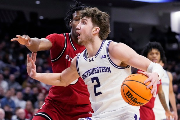 Clippers rookie forward Nick Martinelli, shown playing for Northwestern, drives to the basket as Rutgers forward Bryce Dortch defends during the second half of a Big Ten game on Wednesday, Jan. 29, 2025, in Evanston, Illinois. (AP Photo/Nam Y. Huh)