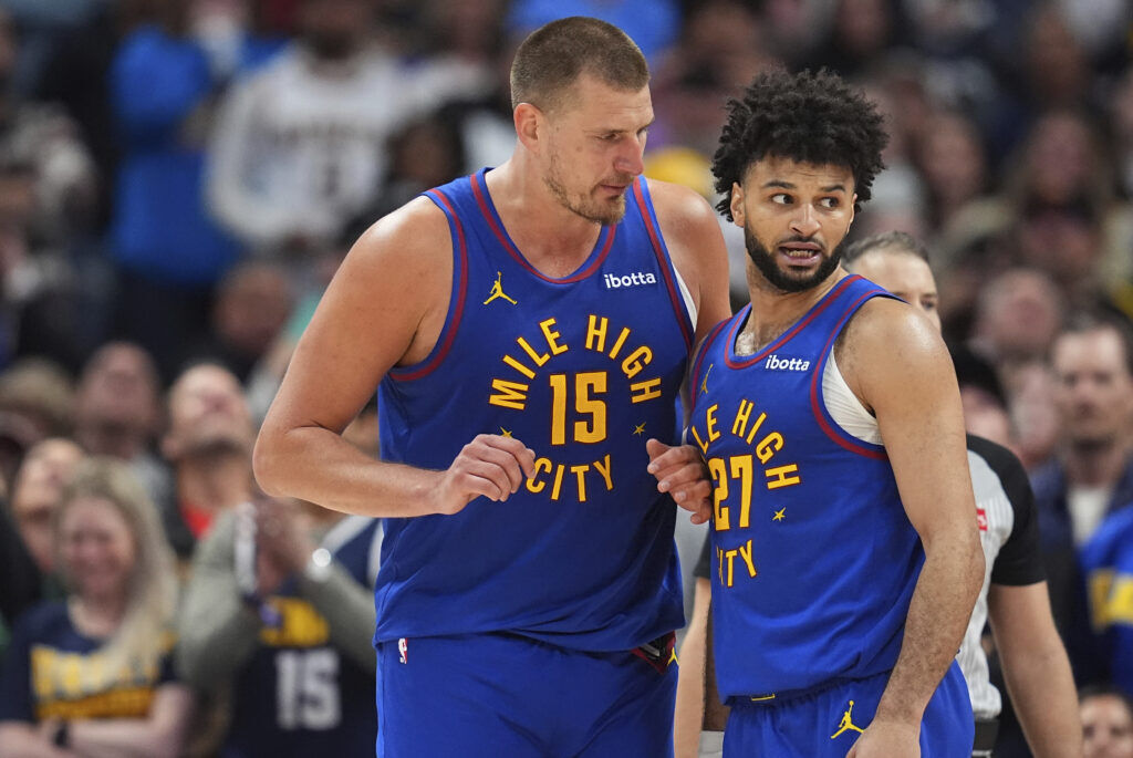 Denver Nuggets center Nikola Jokic (15) confers with Denver Nuggets guard Jamal Murray (27) in overtime of Game 1 of an NBA first-round playoff series Saturday, April 19, 2025, in Denver. (AP Photo/David Zalubowski)
