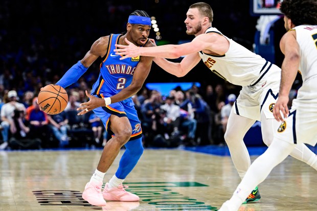 Oklahoma City Thunder guard Shai Gilgeous-Alexander (2) drives against Denver Nuggets guard Christian Braun (0) during the second half of an NBA basketball game Monday, March 9, 2026, in Oklahoma City. (AP Photo/Gerald Leong)