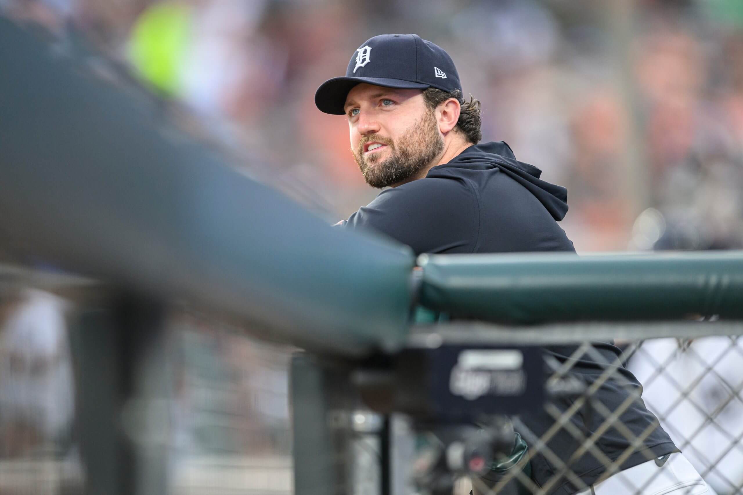 Detroit Tigers pitcher Casey Mize rests in the dugout during a game.
