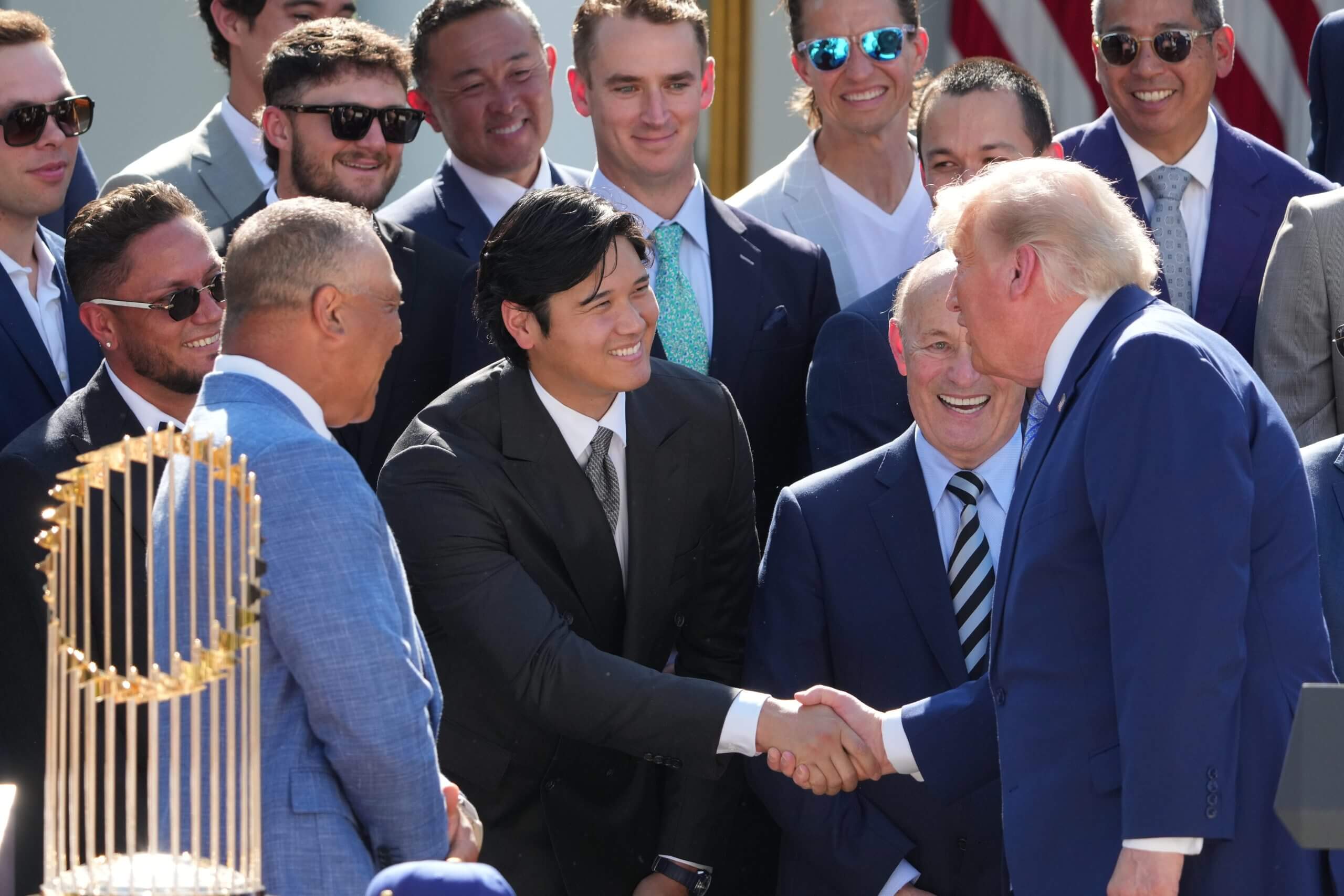 President Donald Trump shakes hands with Shohei Ohtani.