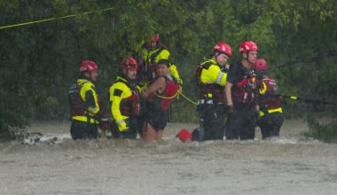 Members of the Boerne Fire Dept. rescue a woman from flood waters on Wednesday, July 15, 2026, in Boerne, Texas. (AP Photo/Darren Abate)